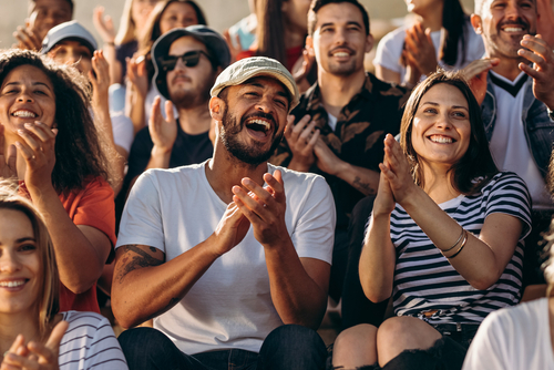 Group of people watching a sporting event and cheering